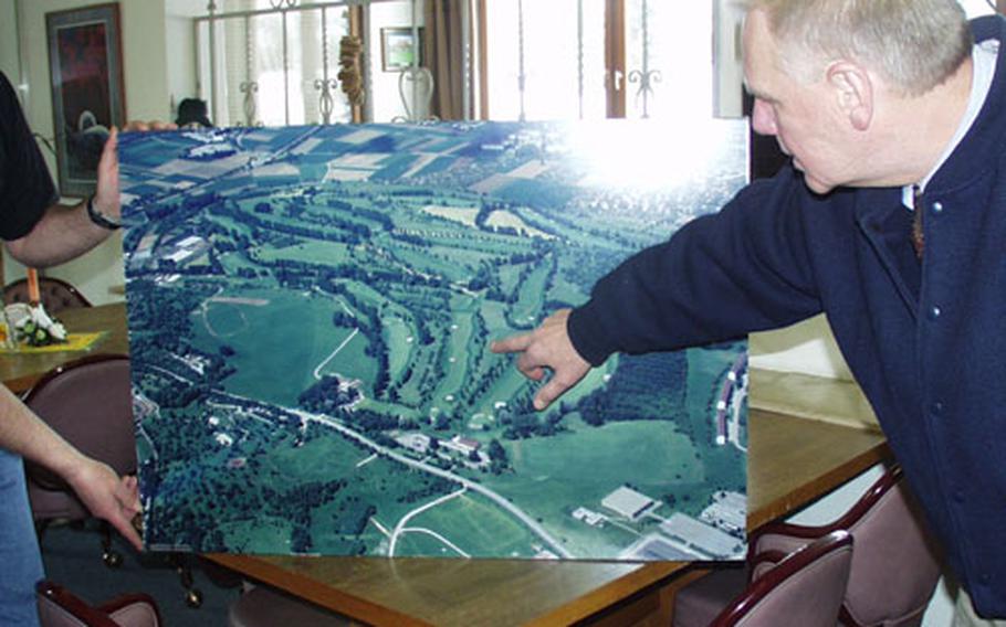 Dennis Maruska, director of community activities of the 6th Area Support Group, points to one of the greens on an old picture of the Stuttgart Golf Course.