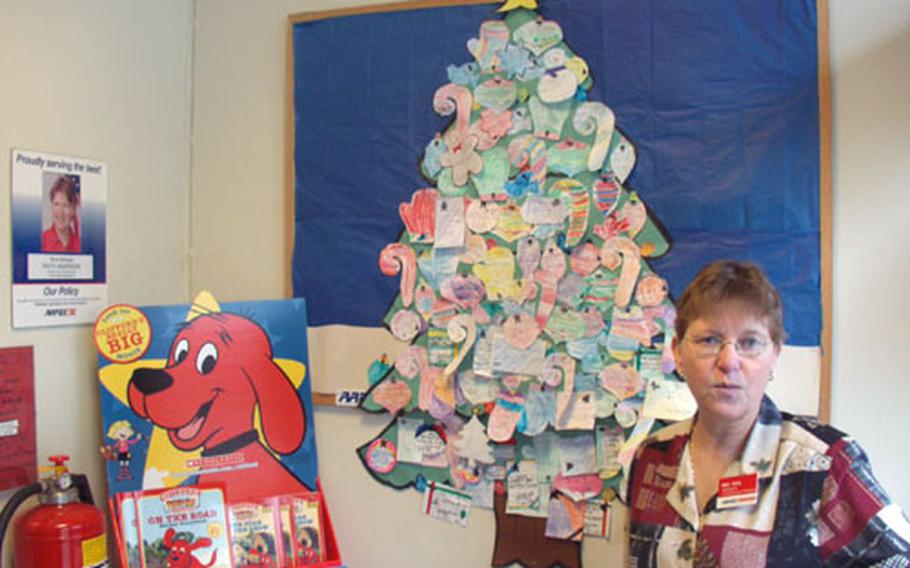 When the winter holidays come around, children in the Benelux area, especially those within the 254th Base Support Battalion region, enjoy "decorating" Patty Anderson's paper Christmas tree.