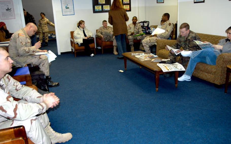 Customers of the Warner Barracks tax center sit in a waiting room Tuesday.