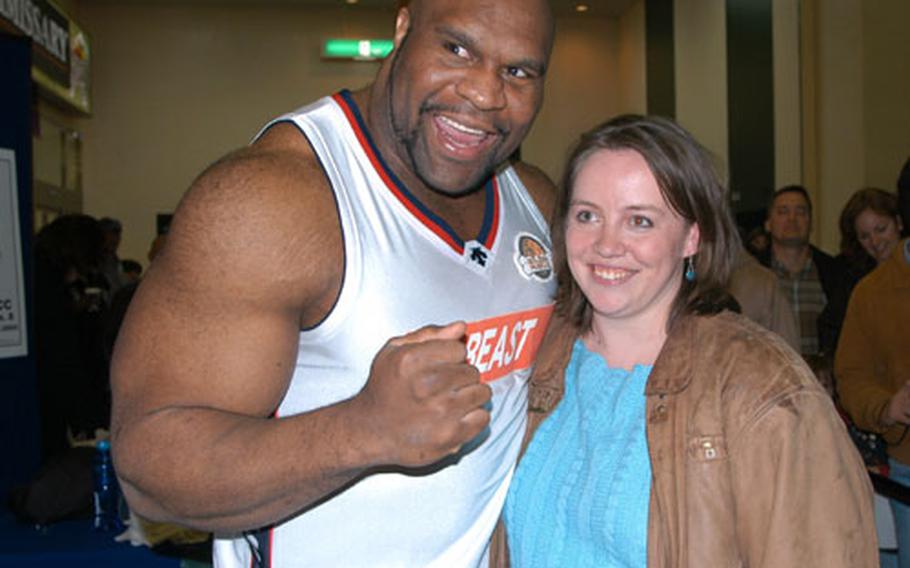 K-1 fighter Bob Sapp hugs Jennifer Tate at Yokota Air Base, Japan, on Sunday. Tate and Sapp graduated together from Mitchell High School in Colorado Springs, Colo.