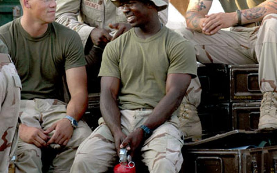 Marines with Company I, 3rd Battalion, 2nd Marine Regiment, 2nd Marine Division from Camp Lejeune, N.C., take a short break from work at Camp Lemonier.