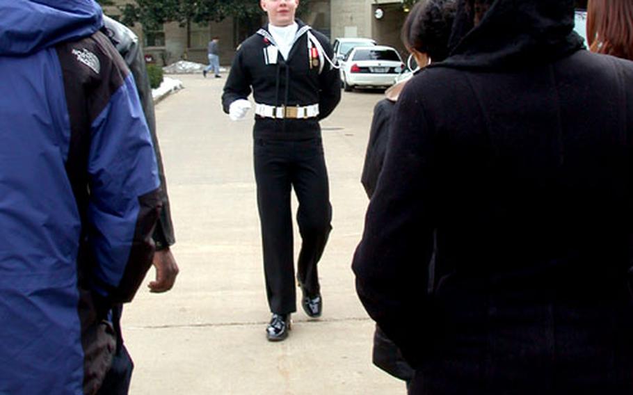 Ensuring guests can hear his narration, Seaman Austin Harnden walks backward for most of the tour that winds through 1.5 miles of hallways at the Pentagon in Arlington, Va.