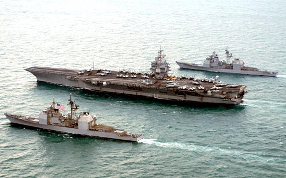 The guided missile cruisers USS Philippine Sea and USS Gettysburg steam alongside USS Enterprise last month in the Persian Gulf.