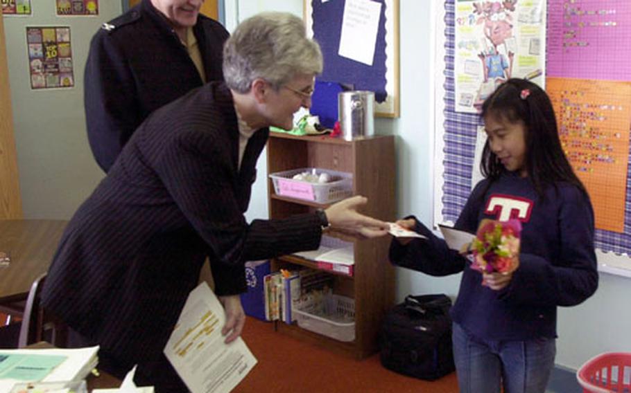 Leianne Jacob, 11, a 5th grade pupil at Sasebo Elementary School, received a $5,000 U.S. Savings Bond on Friday as a first place winner in the A-OK Program sponsored by the Navy Exchange Services Command. She was selected from thousands of entrants worldwide based on her academic effort in maintaining excellent grades during the 4th quarter of the 2002-2003 school year.