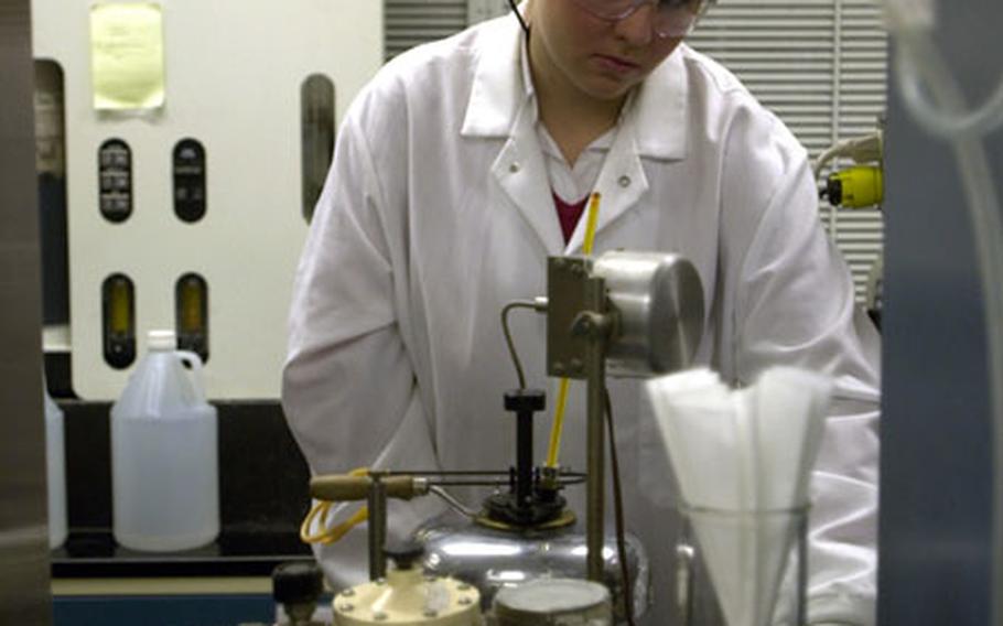 Marisa Fernandez, a chemist at Kadena&#39;s Fuel Lab, tests the flashpoint of JP-8 jet fuel.