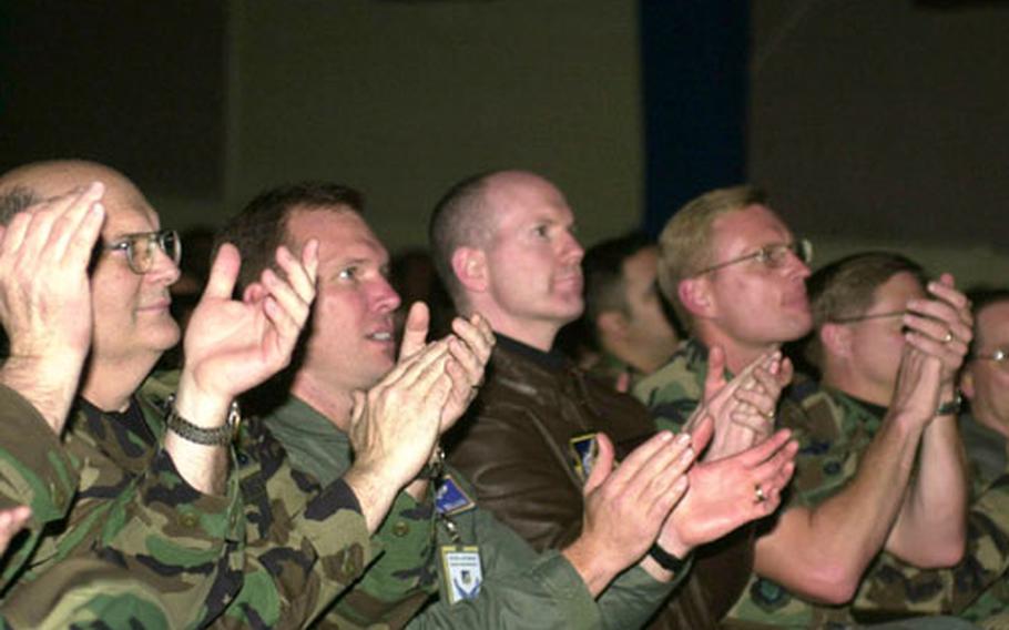 Members of U.S. Air Force's 51st Fighter Wing at Osan Air Base, South Korea, applaud Feb. 17 during outbrief at which Pacific Air Forces inspectors outline results of unit compliance inspection in which they awarded the wing an overall rating of "excellent."