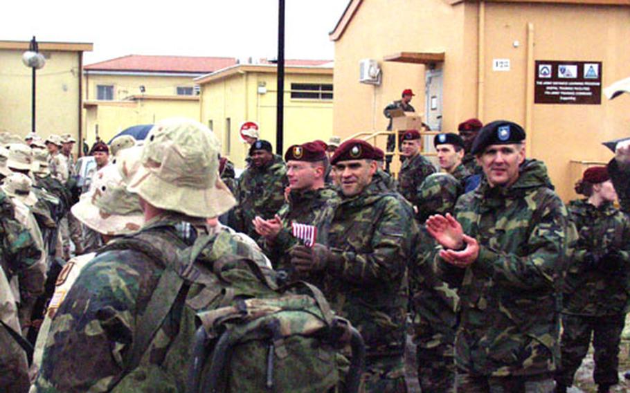 Returning from a long deployment to Iraq, the first large group of soldiers from the 173rd Airborne Brigade are greeted Thursday by other members of the Southern European Task Force (Airborne) at Caserma Ederle in Vicenza, Italy.