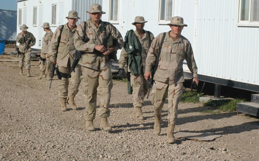 1st Cavalry Division soldiers stroll between the rows of living trailers at Camp Victory North. The 1st Cav soldiers are the first to live at the Army's newest base camp in Baghdad.