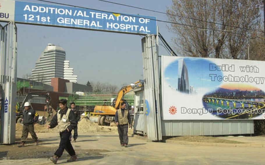 Construction workers at the 121st General Hospital on Yongsan Garrison go on their lunch break. Military officials say they're going ahead with the final phase of a $70.2 million renovation despite an agreement to move all forces off Yongsan by 2007.