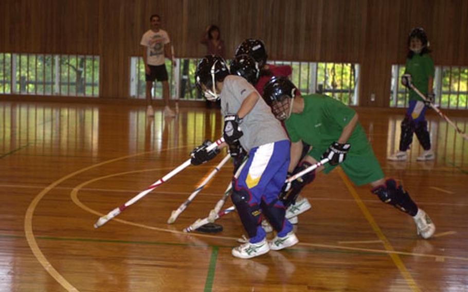 Floor hockey team members at Okinawa Koto Yogo Gakko, a high school for mentally challenged students in Gushikawa, practice for the upcoming Special Olympics Nippon games in Nagano.