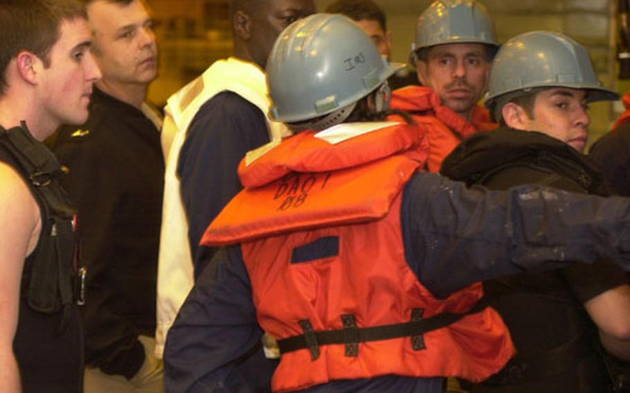 A search-and-rescue team aboard the USS Bataan rushes to board a small boat after a man-overboard call was sounded Thursday night in the Persian Gulf. It turned out to be a false alarm.