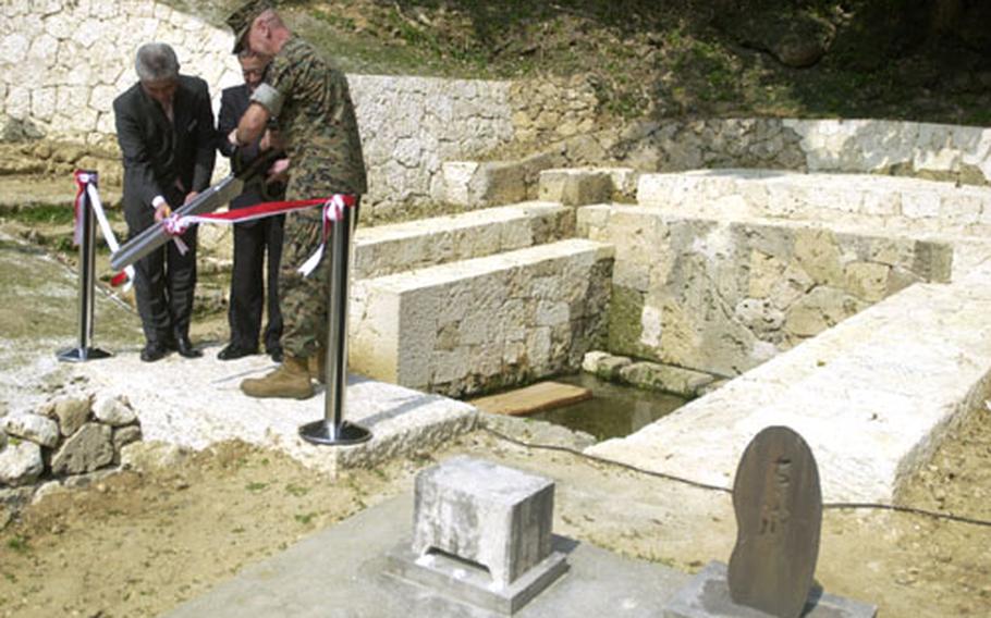 Choko Zukeran, chairman of Chatan Town's Board of Education, Chatan Mayor Choichi Hentona and Col. Glenn Wagner, Camp Commander of Camp Foster (from left) were among about 80 people gathered for a dedication ceremony of a 200-year-old community well on Camp Foster.