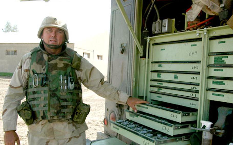 Sgt. Keith Miller of the 878th Engineer Battalion displays the tools he uses to keep the combat heavy engineer equipment running. Miller’s Georgia National Guard unit is clearing the air base for use by the U.S. Army.