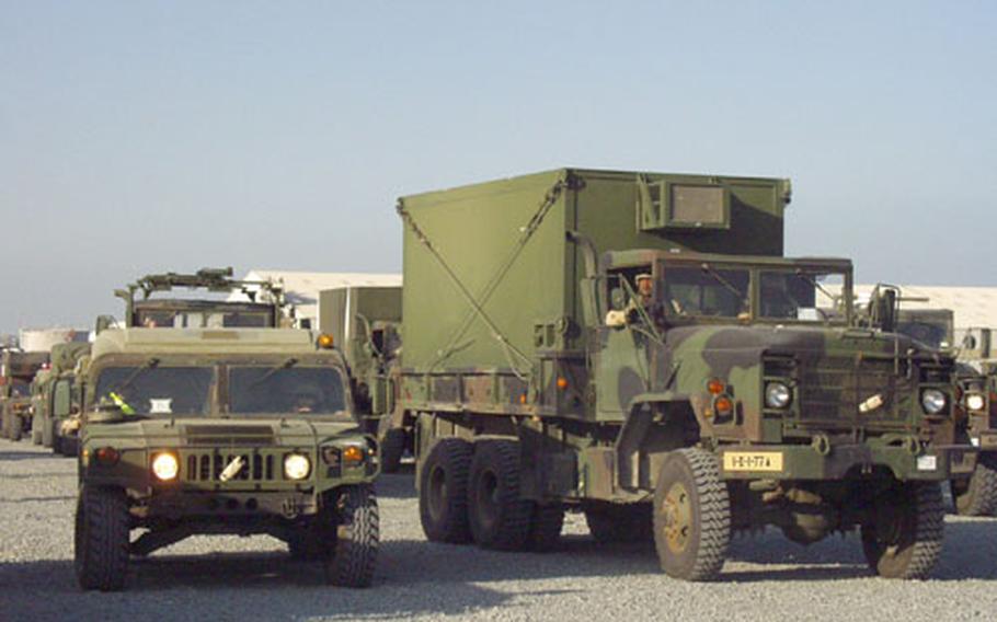 This Humvee and truck from the 1st Infantry Division's 1st Battalion, 77th Armor, began a convoy of vehicles from the port in Kuwait City to Camp New York.