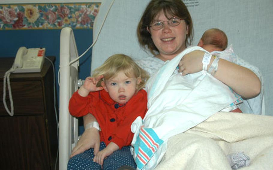 Robin Moeller on Tuesday holds her daughter, Kaylin, and her newborn son, Ethan, who was conceived about two weeks after Moeller's husband Matt, returned last year from deployment on the USS Kitty Hawk. The Moellers are part of a February baby boom at Yokosuka's base hospital. Ethan was born Monday.