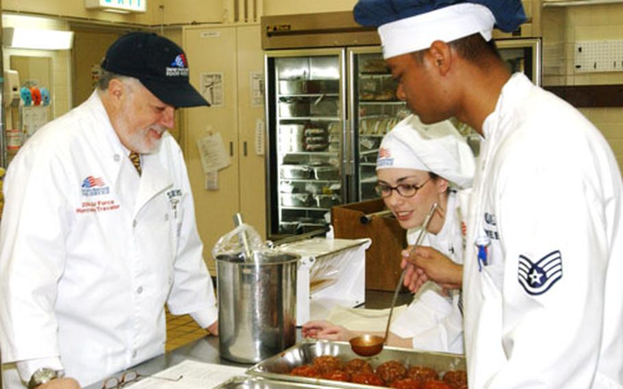 Jim Sellers, of the National Restaurant Association, watches Staff Sgt. Juhmal Webb, and Staff Sgt. Stacy Rodriguez, center, of Misawa Air Base's 35th Services Squadron, on Wednesday. Sellers was one of four team members here to evaluate the base's food service program.