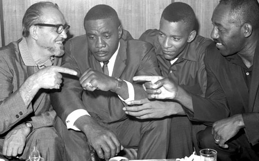 Sonny Liston, second from left, with trainer Joe Polino, left, sparring partner Jim Robinson, right, and assistant trainer Nate Richardson at the Frankfurt airport in August, 1966.