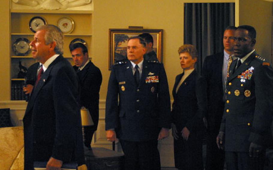 Air Force Chief of Staff, General John Jumper, plays himself, and actor William Devane plays the president during the shooting of a scene in the Oval Office on an episode of Stargate SG-1. The episode starring the chief of staff will air on the Sci-Fi Channel March 19.