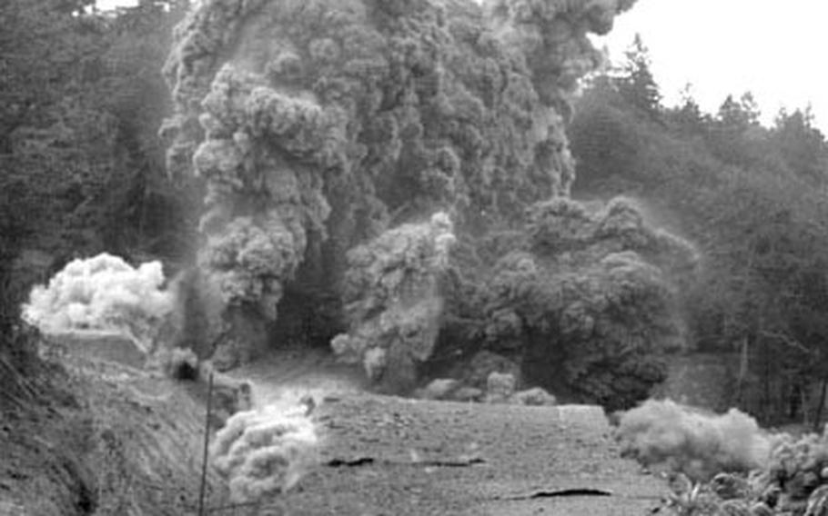 A cloud of smoke and debris flies from the wartime HQ of Field Marshal Gerd von Rundstedt as a ton of TNT tears apart the underground bunker.