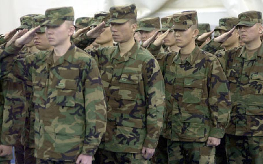 Korean Augmentees to the U.S. Army, or KATUSAs, salute Thursday during their graduation from the KATUSA Training Academy at Camp Jackson, South Korea. The soldiers, conscripted for two years, attend the KTA after completing basic training with Republic of Korea Army soldiers. The KTA introduces them to the U.S. Army way of doing things before they join U.S. Army units for service. KATUSAs wear U.S. Army uniforms with slight modifications (rank and name, in Korean, on pockets).