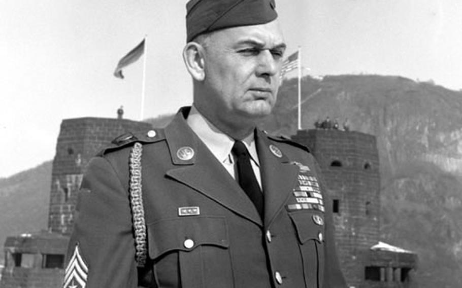 Sgt. Maj. John W. Himes, who was a combat photographer during the battle, stands in front of the ruins in 1962.