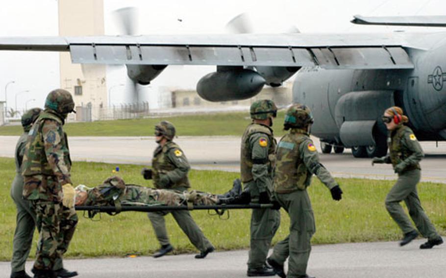During an exercise Thursday, teams of medical personnel from Kadena Air Base loaded "patients" on stretchers and carried them onto a C-130 cargo aircraft at Kadena Air Base for transport.