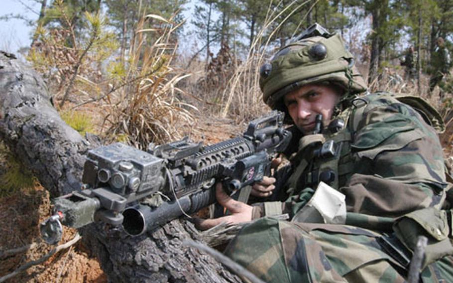 Pfc. Jake Perry pulls security after his infantry team overran an "enemy" bunker at Rodriguez Range Tuesday.