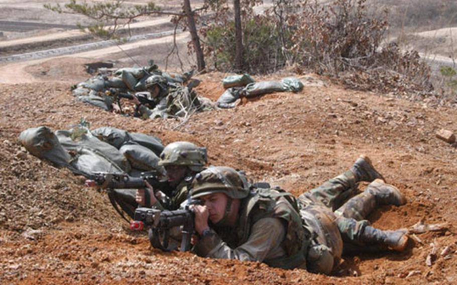 Soldiers from 1-9 Infantry Battalion&#39;s Headquarters and Headquarters Company, acting as the opposing force, guard a bunker complex during training at Rodriguez Range Tuesday.