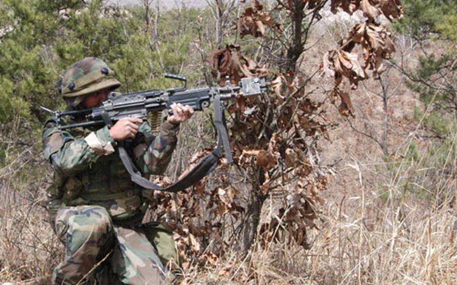 An A Company soldier fires at the "enemy" at Rodriguez Range Tuesday.