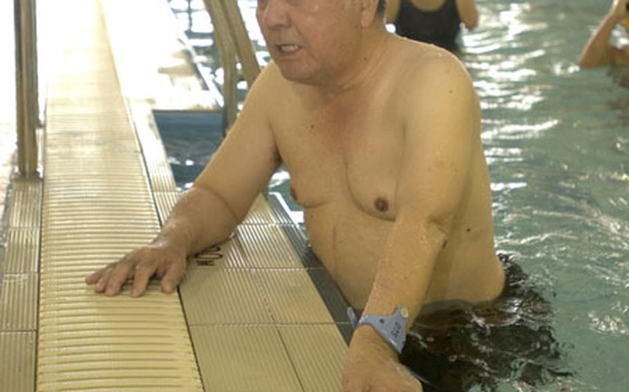 Michio Okumoto, Urasoe City Council Member, 66, takes a break from his daily swiming exercise at the Majun Land recreation center.