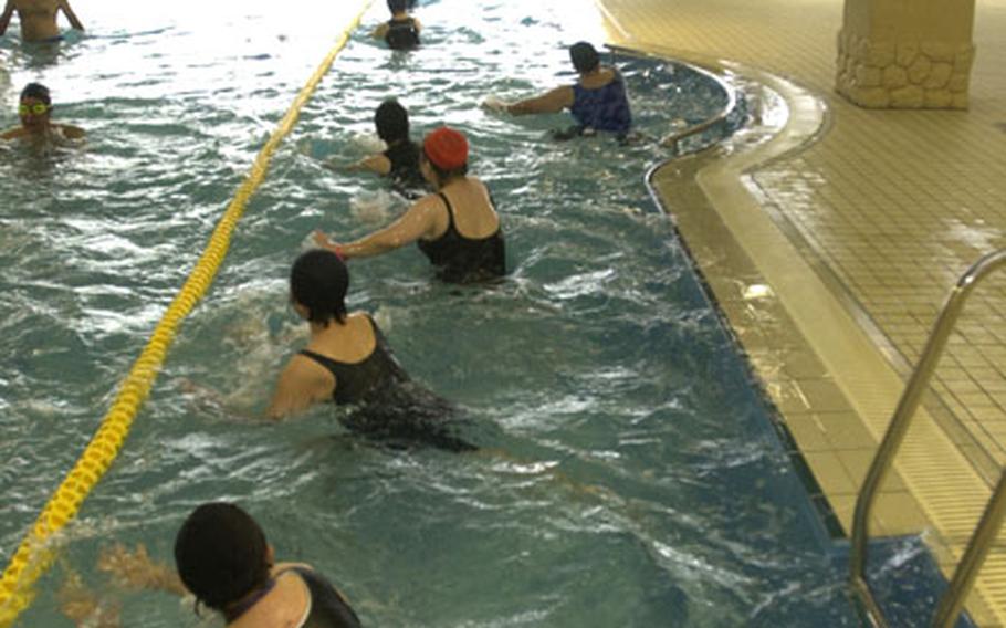 Swimmers exercise at the Majun Land, a recreation center in Urasoe. The city started a weight loss campaign April 1.