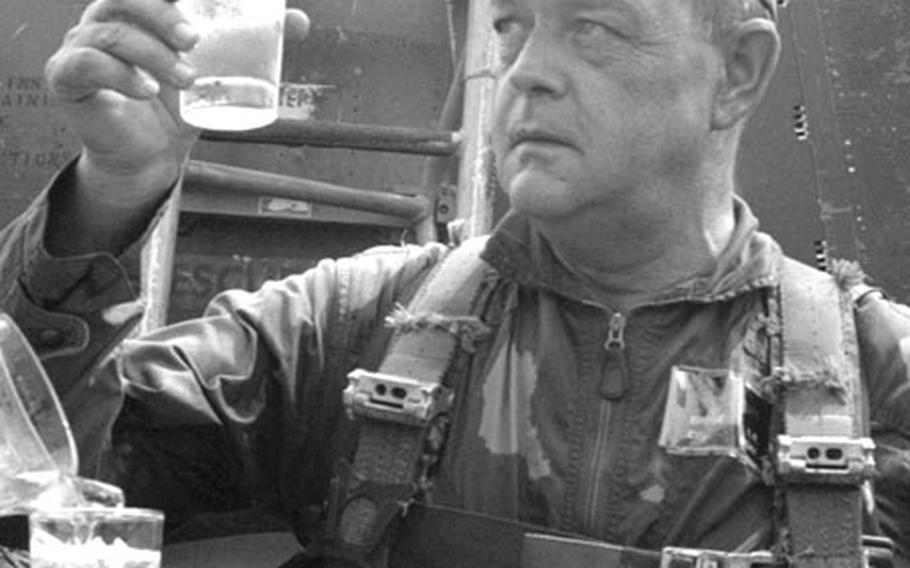 Col. Levi Chase concentrates on a much-needed glass of ice water after completing his 500th fighter mission in September, 1966.