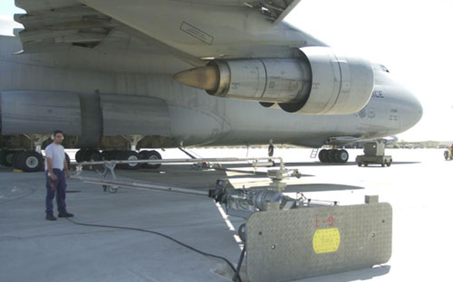 Jorge Bastida, left, a Spanish civilian worker, and Senior Airman Frank Skala pump jet fuel to a C-5 Galaxy parked at Morón Air Base, Spain, on Wednesday. The small base last month pumped its 100 millionth gallon of fuel for Operation Iraqi Freedom.