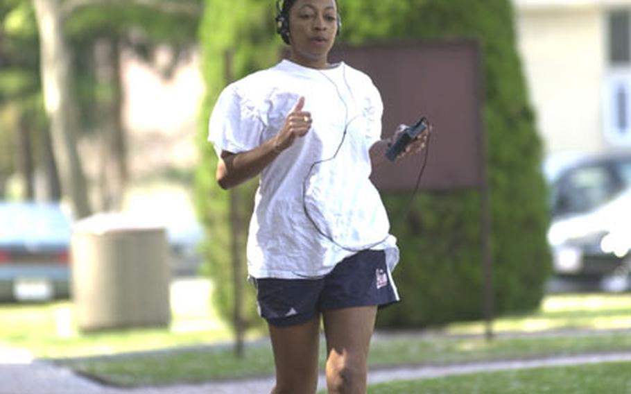Tech. Sgt. Jennifer Shelton of the Air Force Office of Special Investigation stays in shape by running the track by the main gym at Yokota Air Base.