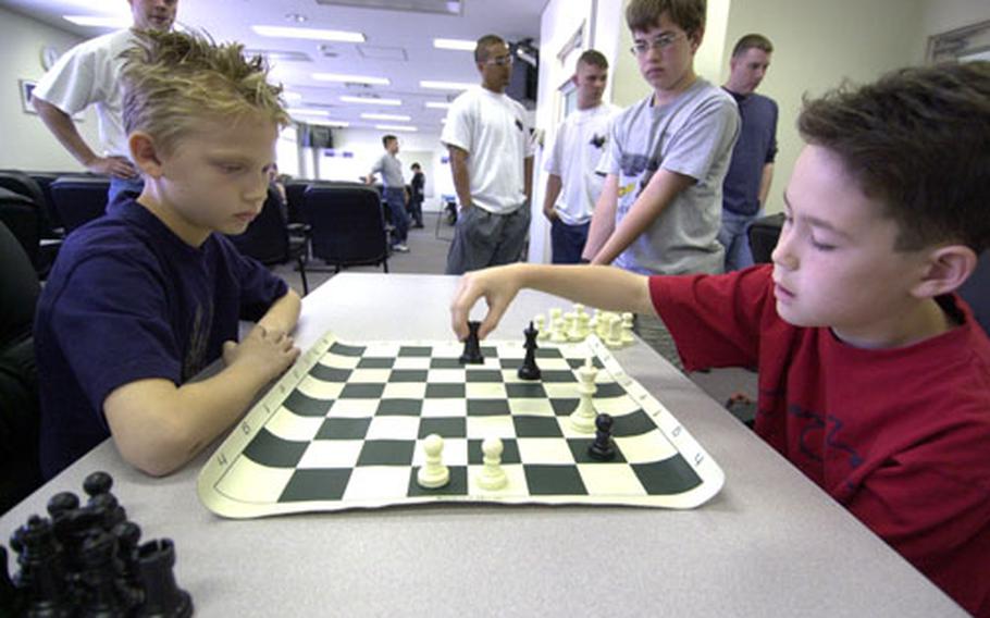 (From left) Patrick Nettie, age 9, and Aaron Posey, age 9, duel it out in a tournament chess game at the Taiyo Recreation Center at Yokota Air Base.