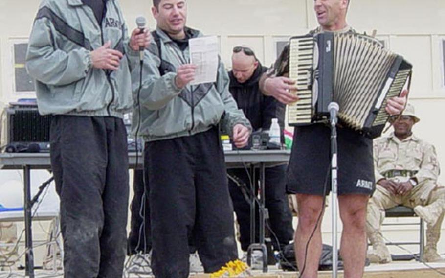 Dr. (Capt.) Lou Giangiulio plays "Volare" on accordion during the Kandahar airfield's holiday talent show late last year as Capt. Alex Giambone (left) and Capt. Mark Maitag sing along.