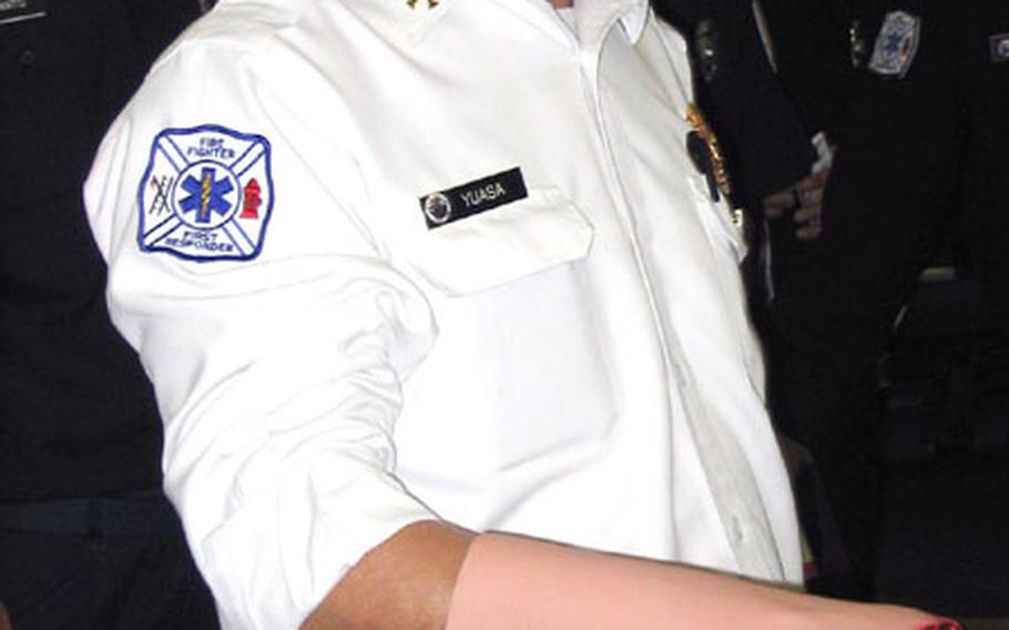 Firefighter Yuasa Toshihiro of the Commander U.S. Naval Forces Japan Regional Fire Department, Sasebo Detachment, on Wednesday volunteered as the "model" during a triage training session conducted by personnel from Sasebo's Navy Branch Medical Clinic in the Community and Education Center.