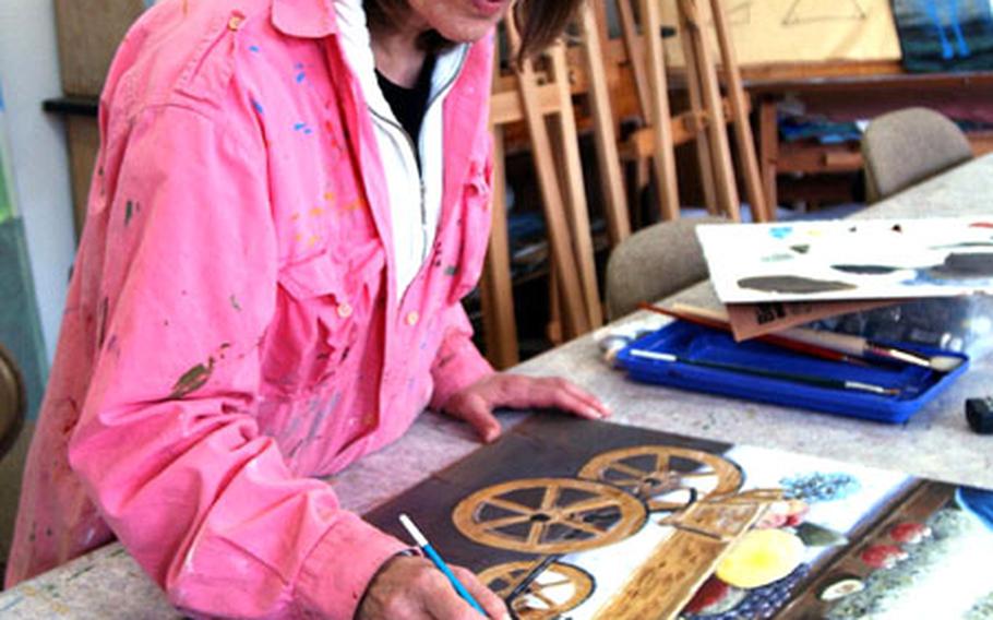 Römer Art Center instructor Christel Santos works on a painting she plans to sell at the annual Spring Arts Festival, May 2-31. Santos teaches oil painting, tole painting, basic stained glass and pattern sewing at the art center on Wiesbaden Army Airfield.