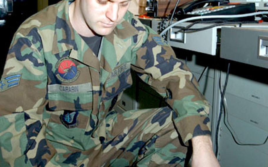 Senior Airman George Carabin, 8th Communications Squadron, runs a “bit error rate” test from Kunsan Air Base to Osan Air Base. His unit recently won an award for best of its size in the Pacific.