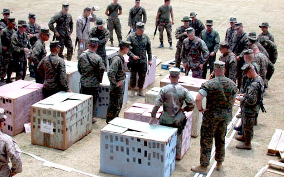 Commanders of the various platoons and companies of the 3rd Battalion, 8th Marines go through a "rock walk" on Tuesday, a dry run through a model of the apartment complex raided Wednesday morning.
