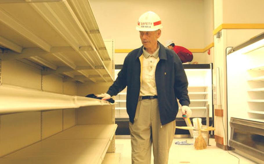 A worker cleans some recently installed shelves at a new commissary being built at Kunsan Air Base in South Korea. The new, larger commissary is to open in June and will offer more items than the base&#39;s existing commissary.