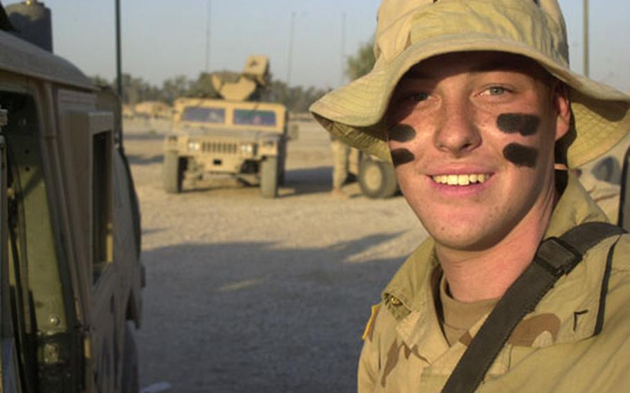 Pvt. Tyler Branecky, an infantryman assigned to 1st Cavalry Division scouts, displays his war paint as teams of rocket spotters prepare to leave Camp Victory North, Iraq, at dusk. Branecky is assigned to Dark Horse Scouts — Troop D, 9th Cavalry Regiment of the 2nd Brigade Combat Team.