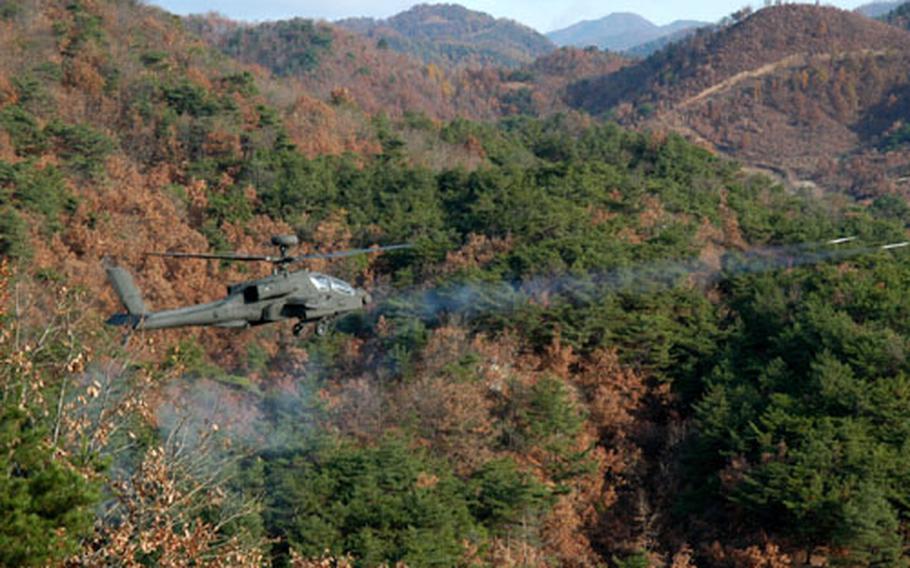 An AH-64D Apache Longbow attack helicopter fires rockets during gunnery qualification at a range in South Korea. Helo is from the 3rd Squadron, 6th Cavalry Brigade, based at Camp Humphreys.