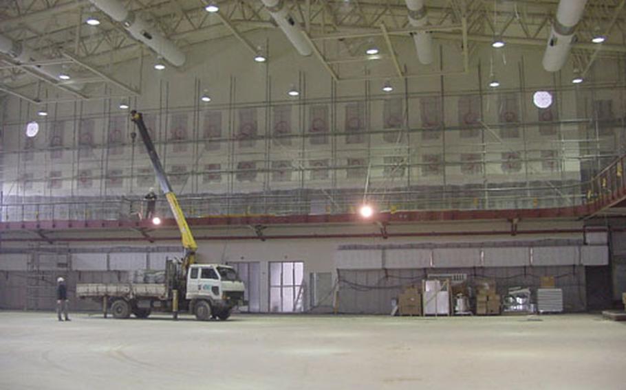 Construction continues on a cavernous new fitness center at Kunsan Air Base, South Korea. The center, shown here in a January 2004 photo, is set to open in July and will be twice the size of Kunsan's existing gym, a one-story structure built in 1963.
