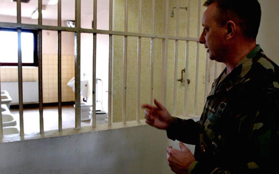 Maj. Jeffery Cromwell, commander of the 9th Military Police Detachment explains planned upgrades to inmate blocks at the U.S. Army Correctional Facility in Mannheim.
