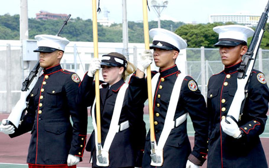 The JROTC Color Guard at Kubasaki High School, from left, Joshua Berardo, Jessica Girard, Dennis Gonzalez and Vince McClure, practices in preparation for the the National High School Drill Team Championships in Daytona Beach, Fla., beginning May 1. The 15-member team, the only DODDS representative, leaves for Florida on Saturday.