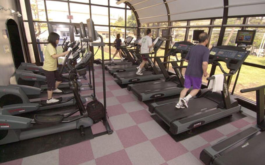 The new gym at Atsugi Naval Air Facility has individual televisions and DVD players for the cardio machines and an open-air feeling from the large windowed rooms.