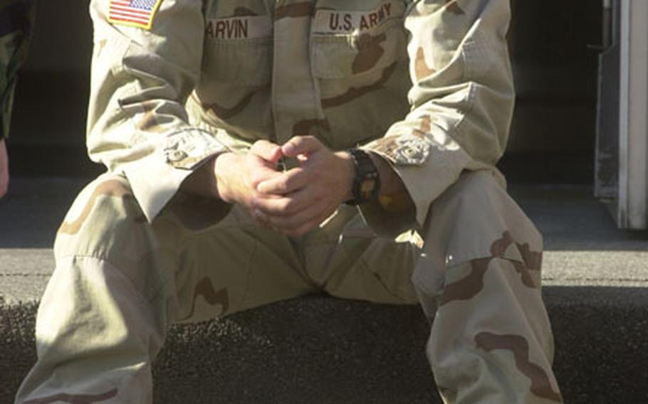 Spc. Robert Garvin, an intelligence analyst for 1st Armored Division, sits outside his barracks in Wiesbaden, Germany, waiting to return to Iraq.
