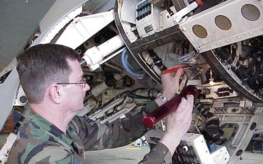 Tech. Sgt. Roy Giddens, 52nd Aircraft Maintenance Squadron, inspects wiring on an upgraded F-16 at Spangdahlem Air Base, Germany.