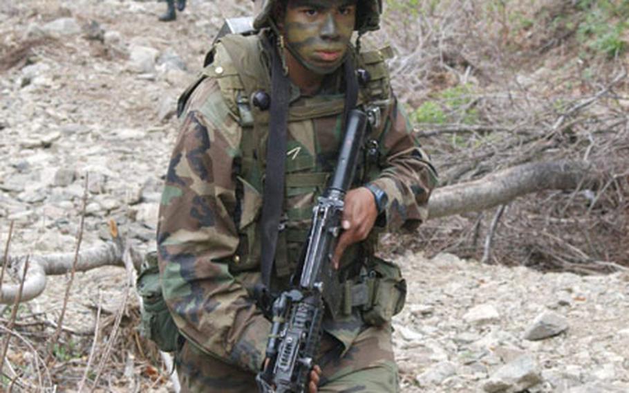 Soldiers from the 2nd Infantry Division's C Company, 1st Battalion, 503rd Infantry Regiment march up a creekbed during training at Blackhawk Range this week.